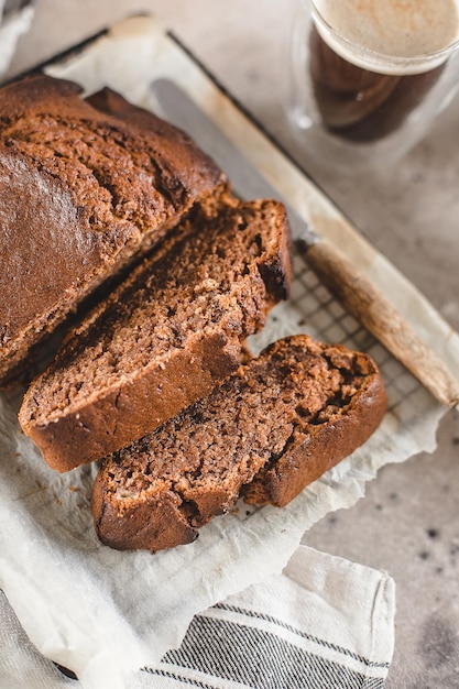 Banana bread sliced with coffee Vegan pasrty Home bakery concept Closeup