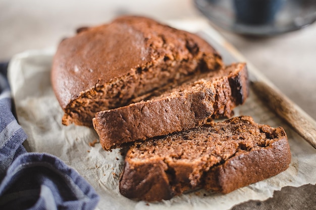 Banana bread sliced with coffee Vegan pasrty Home bakery concept Closeup