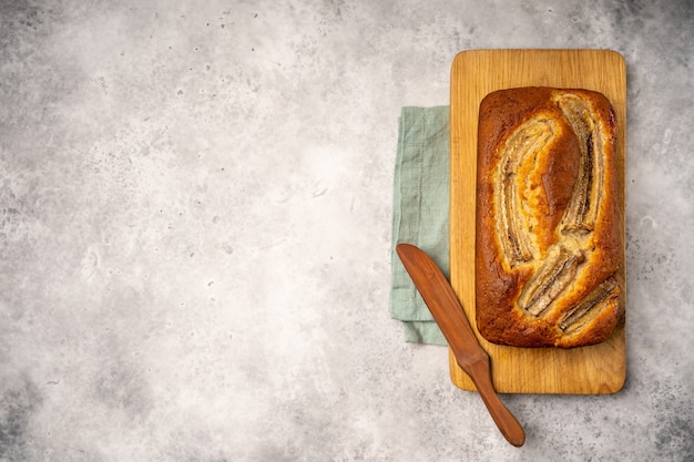 Banana bread on a wooden board, linen napkin