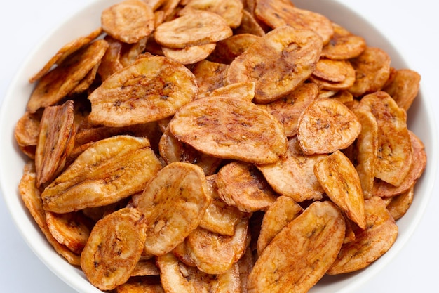 Banana chips on white background