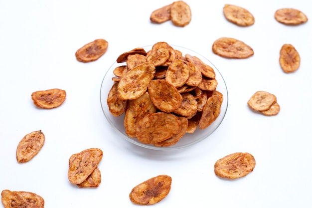 Banana chips on white surface