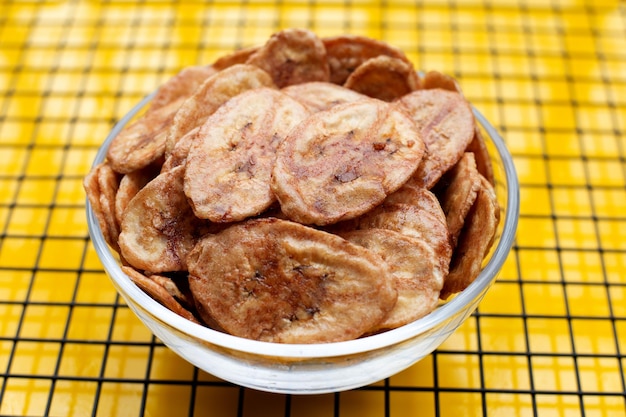 Banana chips on yellow background