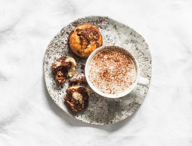 Banana chocolate cakes and cappuccino on a light background top view Delicious dessert breakfast