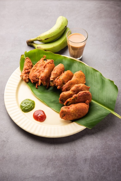 Banana Fritter or pakora or raw kela pakodaÃÂ or bajji served with chutney. Popular snack from Kerala, India or Indonesia. served with tea