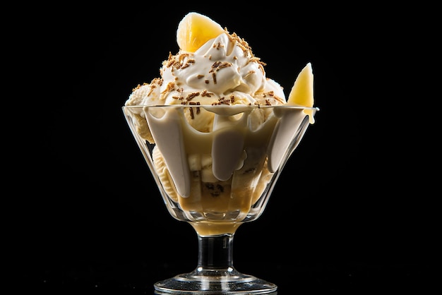 Banana ice cream in a glass cup on a black background