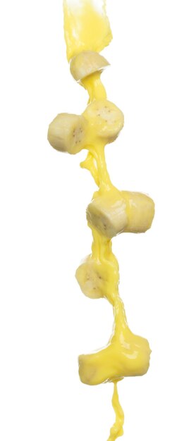 Banana juice flying fall down yellow banana chopped slice juice wave explode Yellow paint color splash throwing in Air White background Isolated high speed shutter throwing freeze stop motion