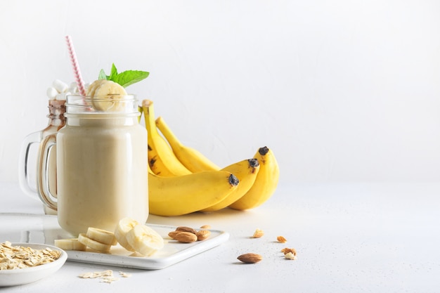 Banana milkshake on white board. Vertical format