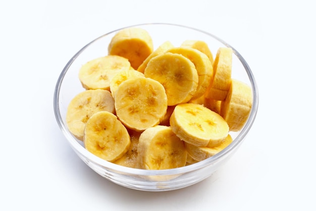 Banana slices in glass bowl on white background