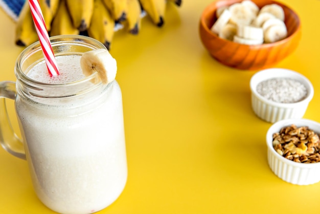 Banana smoothie shake healthy shake with bananas in the background