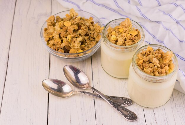 Banana yogurt with granola in jars. 
