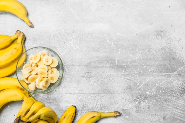 Bananas and banana slices in a glass plate