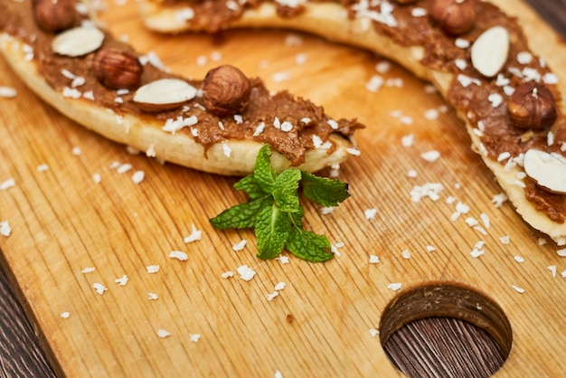 Bananas with peanut butter almonds and nuts healthy snack