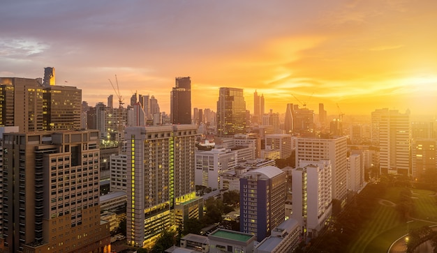 Bangkok City skyline with urban skyscrapers at sunset.