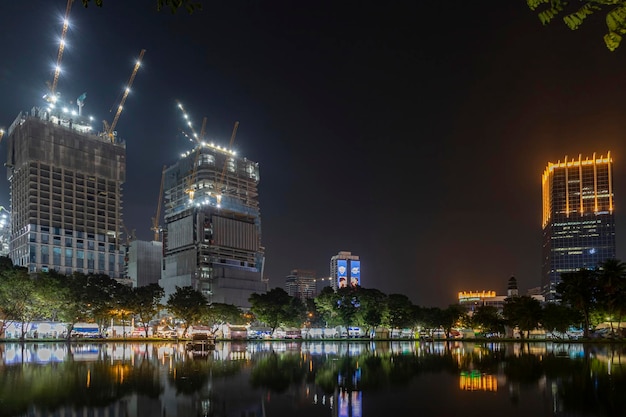 Bangkok Thailand Dec 8 2022Waterfront view of Lumpini Park at night on the day of the Red Cross Fair Causing there to be lights along the riverside path beautiful atmosphere Between 818 Dec 2022