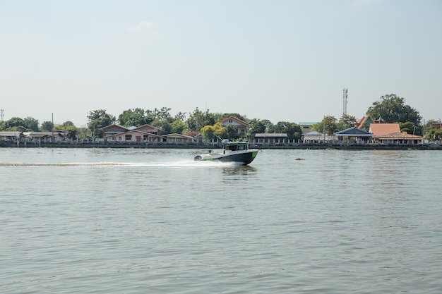 Bangkok, THAILAND - December 12, 2021: Atmosphere of Chao Phraya river the Speed boat Ship is moving in the evening time.