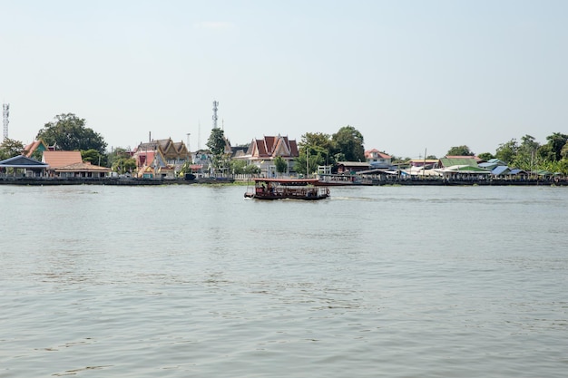 BANGKOK, THAILAND - December 12, 2021: Tourists boat of bangkok crosses the Chao Phraya River.