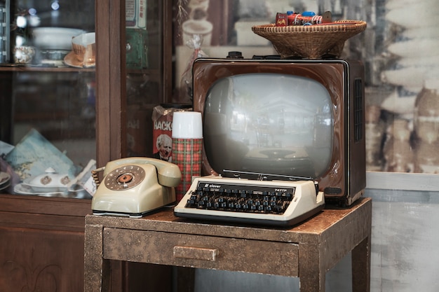 Photo bangkok, thailand, january 5, 2020: retro interior - old tv, typewriter and dial phone