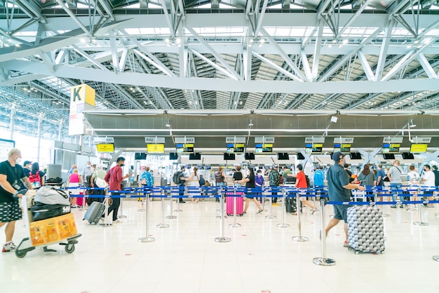 Bangkok Thailand May 23 2022 Bangkok Suvarnabhumi airport passengers inside the departure terminal people in medical masks from coronavirus