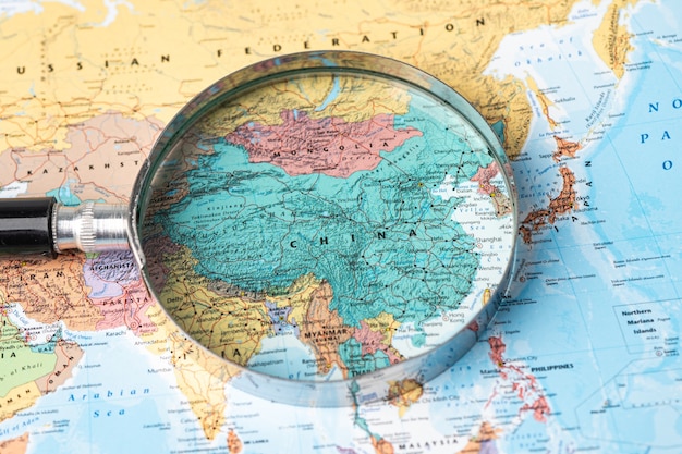 Bangkok, Thailand - November 01, 2020 China, Magnifying glass close up with colorful world map