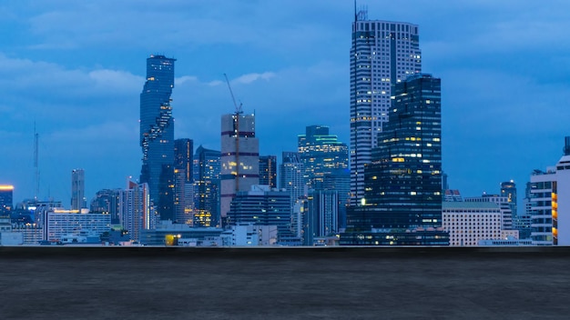 Bangkok urban cityscape skyline night scene with empty loft cement floor on front