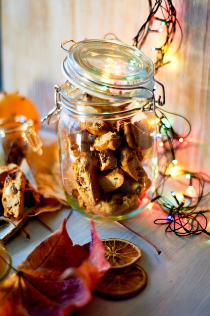 Bank cookies and biscottiLuminous garland and autumn leaves Warm romantic evening