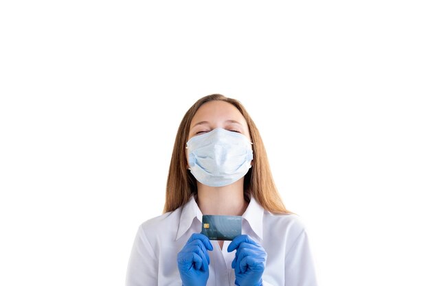 Bank credit Online payments Covid19 restriction Happy woman in formal shirt medicine mask gloves holding plastic card dreamfully closing eyes isolated on white New normal