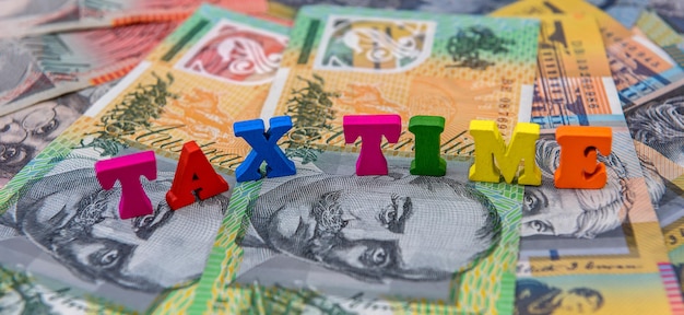 Bank note of Australia with text tax time Annual report finance concept