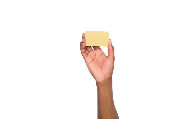 Banking services. Black male hand holding blank plastic credit card on white isolated studio background, copy space, cutout