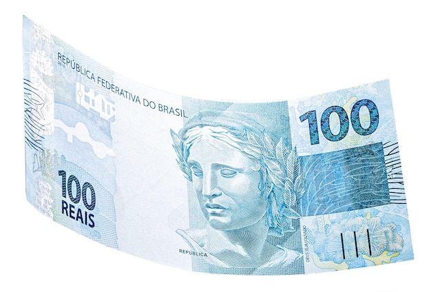 Banknote of one hundred reais from brazil falling on isolated white background