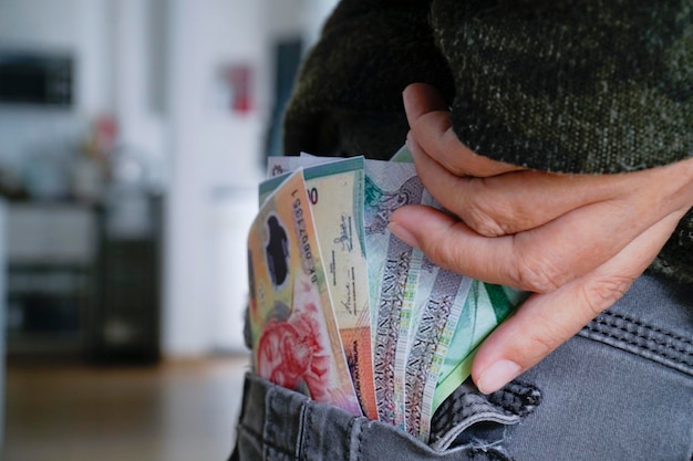 Banknotes in pants pocket closeup spending money