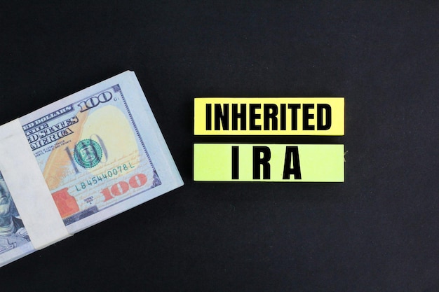 banknotes and paper colored with the word Inherited IRA business concept