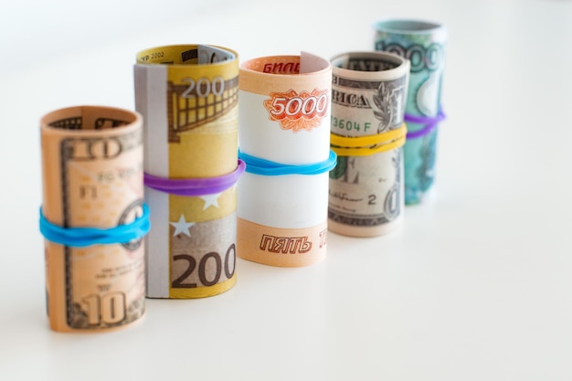 Banknotes rolled into a tube stand in a row dollar euro ruble