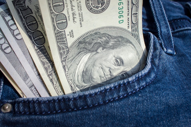 Banknotes sticking out of a pocket of jeans