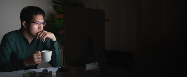 Banner of attractive young asian man drinking coffee sitting