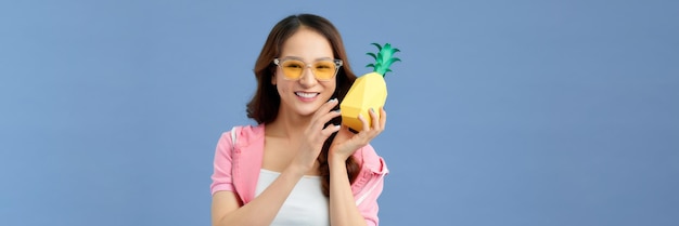 Banner of a beautiful asian woman with pineapple in blue background