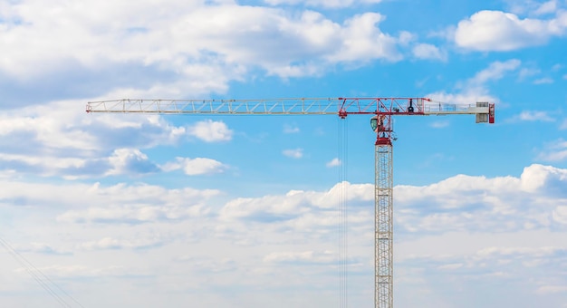 Banner construction crane on a sky background, clouds.