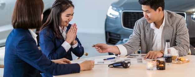 Banner and cover scene of Asian customer giving the credit card to sales representative