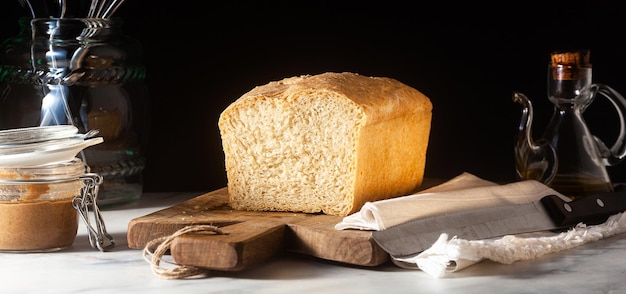 Banner of Fresh homemade Toast bread on the kitchen table dark background