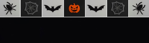 Banner for Halloween Decorative spiders pumpkins spider web and bat on the black and gray background Copy space Top view