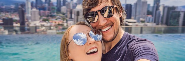 Banner long format young happy and attractive playful couple taking selfie picture together at