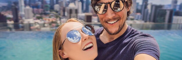 Banner long format young happy and attractive playful couple taking selfie picture together at