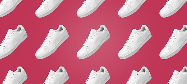 Banner pattern of white sneakers isolated on Viva Magenta background. Sportive pair of shoes.