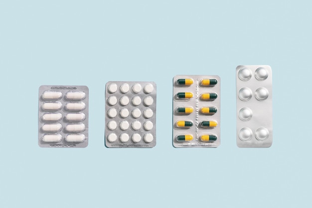 Banner with medicine pills and tablets on blue background