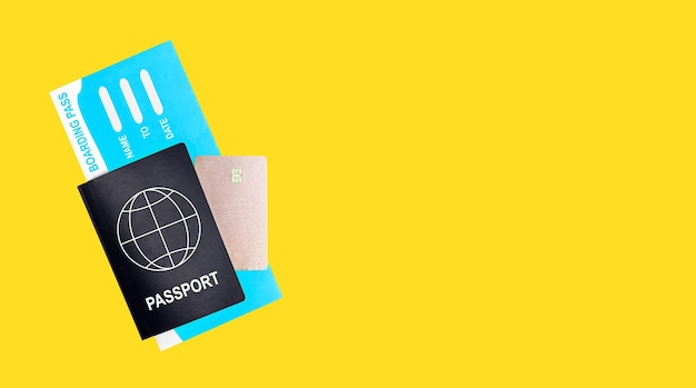 Banner with passport boarding pass and credit card on yellow background Travelling by air concept Documents for going abroad by plane Copy space