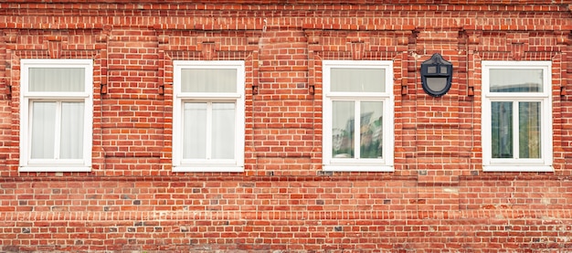 Photo banner with red brick wall and white vintage windows