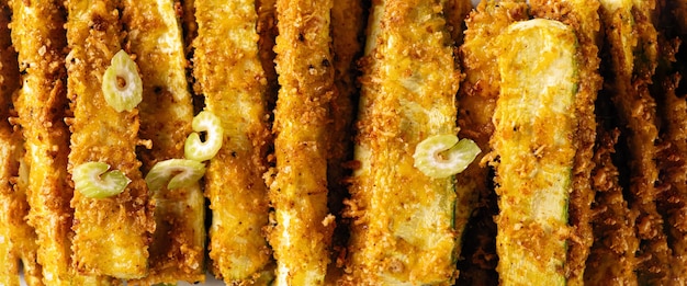 Banner zucchini baked in breaded close-up, background