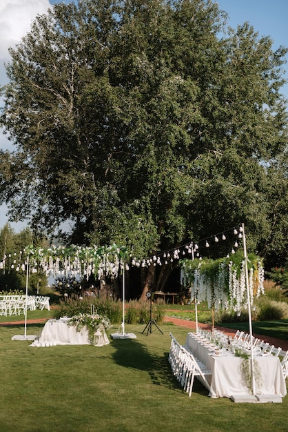 Banquet in the garden for a wedding with decorative elements atmospheric decor