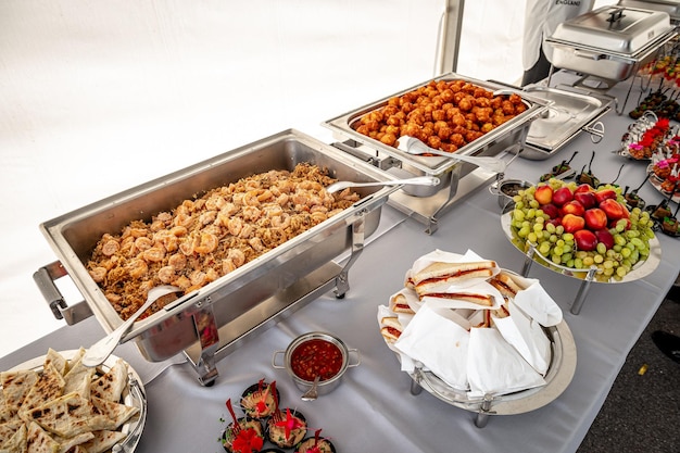 Banquet table with chafing dish heaters Buffet with hot dishes Rice with shrimp