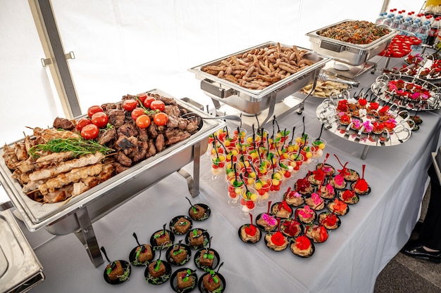 Banquet table with chafing dish heaters Grilled meat