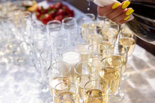 A banquet table with wine glasses and plates with strawberries